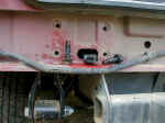 The bumper is attached to the body with four bolts on each side.