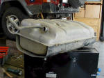 The dented factory tank removed from the Jeep